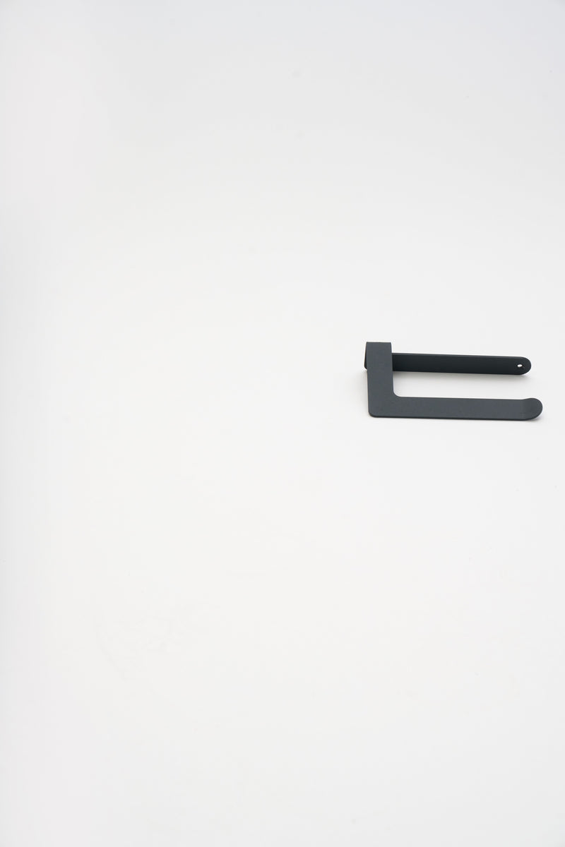 A minimalist set of ATYP steel bathroom pieces arranged as a flat lay