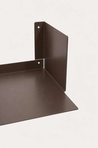LUMO living room shelf in Umber powder coated steel, RAL 8022, corner close-up of the U profile, dark chocolate brown
