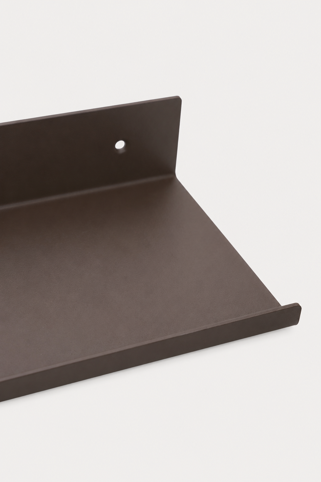 LUME bedroom shelf in Umber powder coated steel, RAL 8022, close-up of the shelf ledge and front lip, dark warm brown