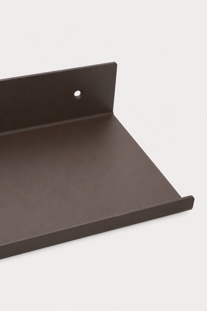 LUME bedroom shelf in Umber powder coated steel, RAL 8022, close-up of the shelf ledge and front lip, dark warm brown