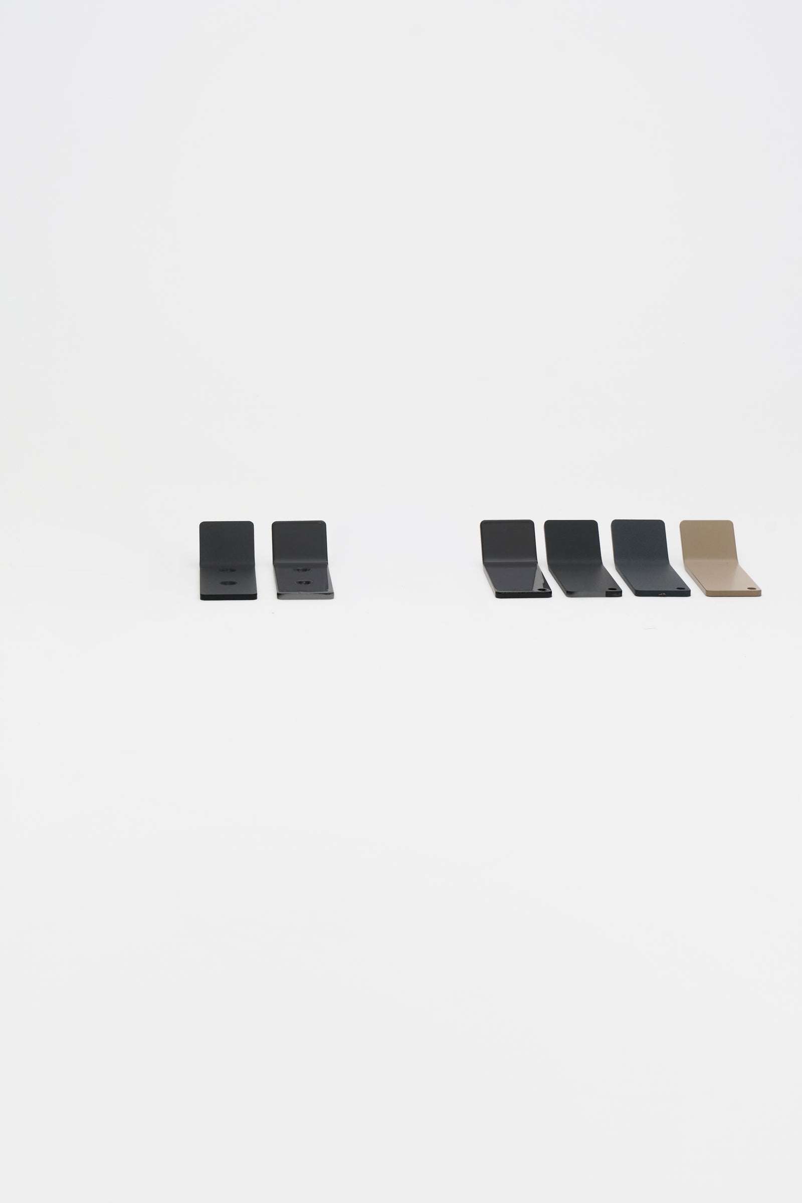 The full ATYP family of powder coated steel pieces laid out together in the workshop studio.