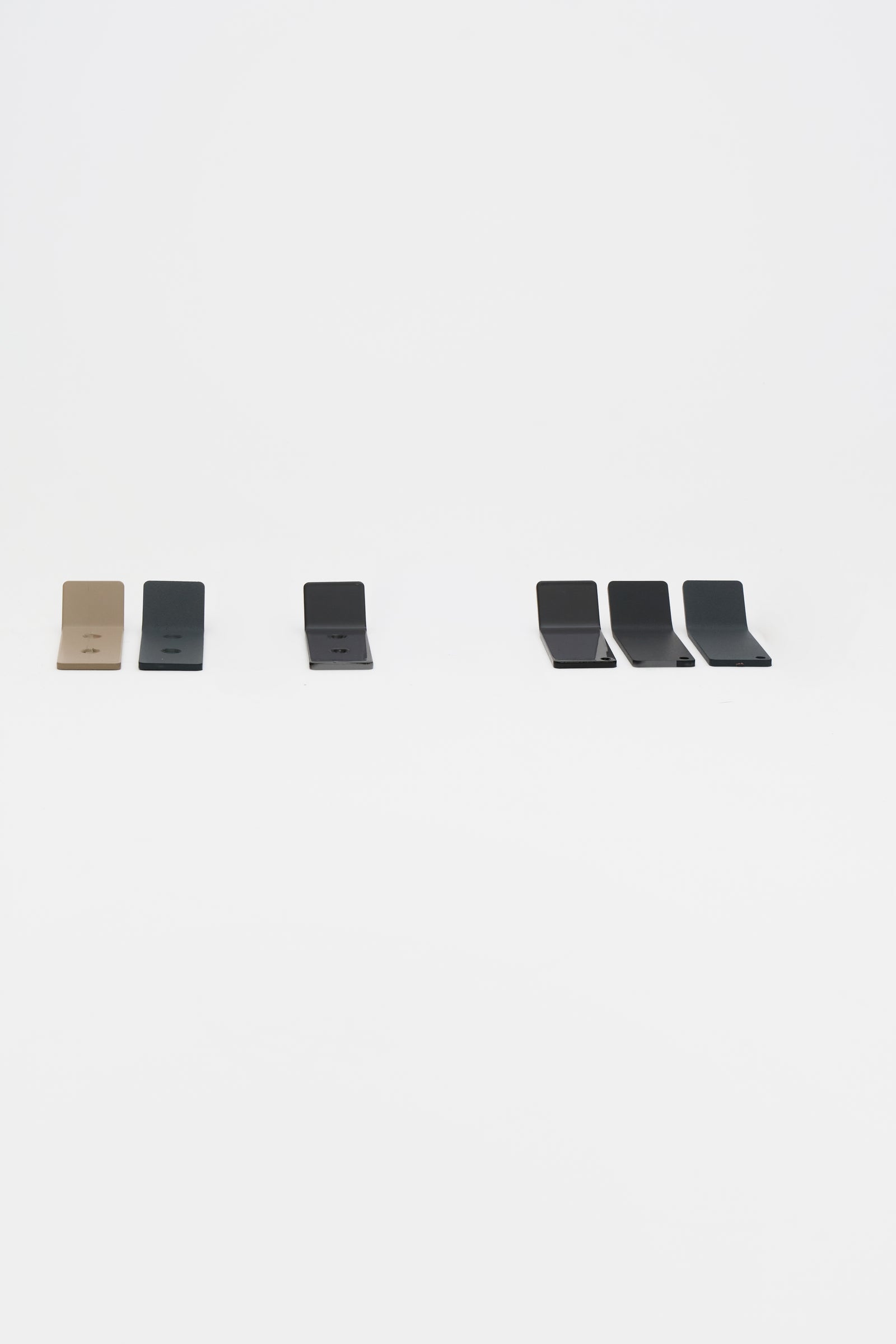 ATYP pieces in every powder coated finish arranged side by side, showing the even matte surface of each color.