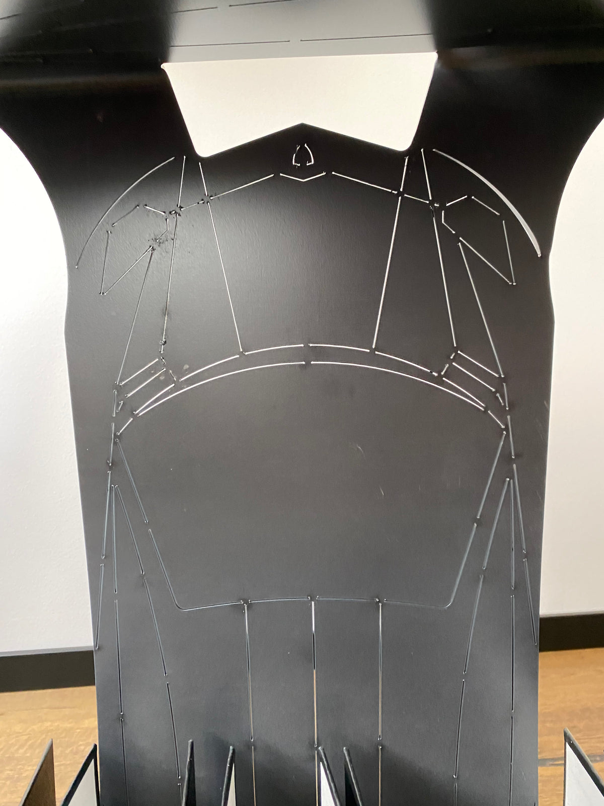 A custom cut steel panel with a fine wire pattern, photographed in the ATYP workshop.
