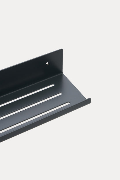 ELIORA shower shelf in powder coated steel, close-up of the slotted tray and front lip, jet black
