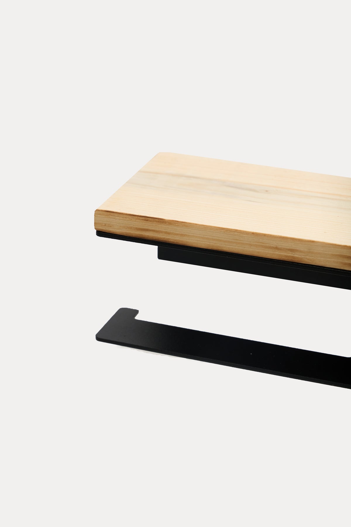 NYVE toilet paper holder in powder coated steel, pale ash wood top over the black steel holder and hook arm