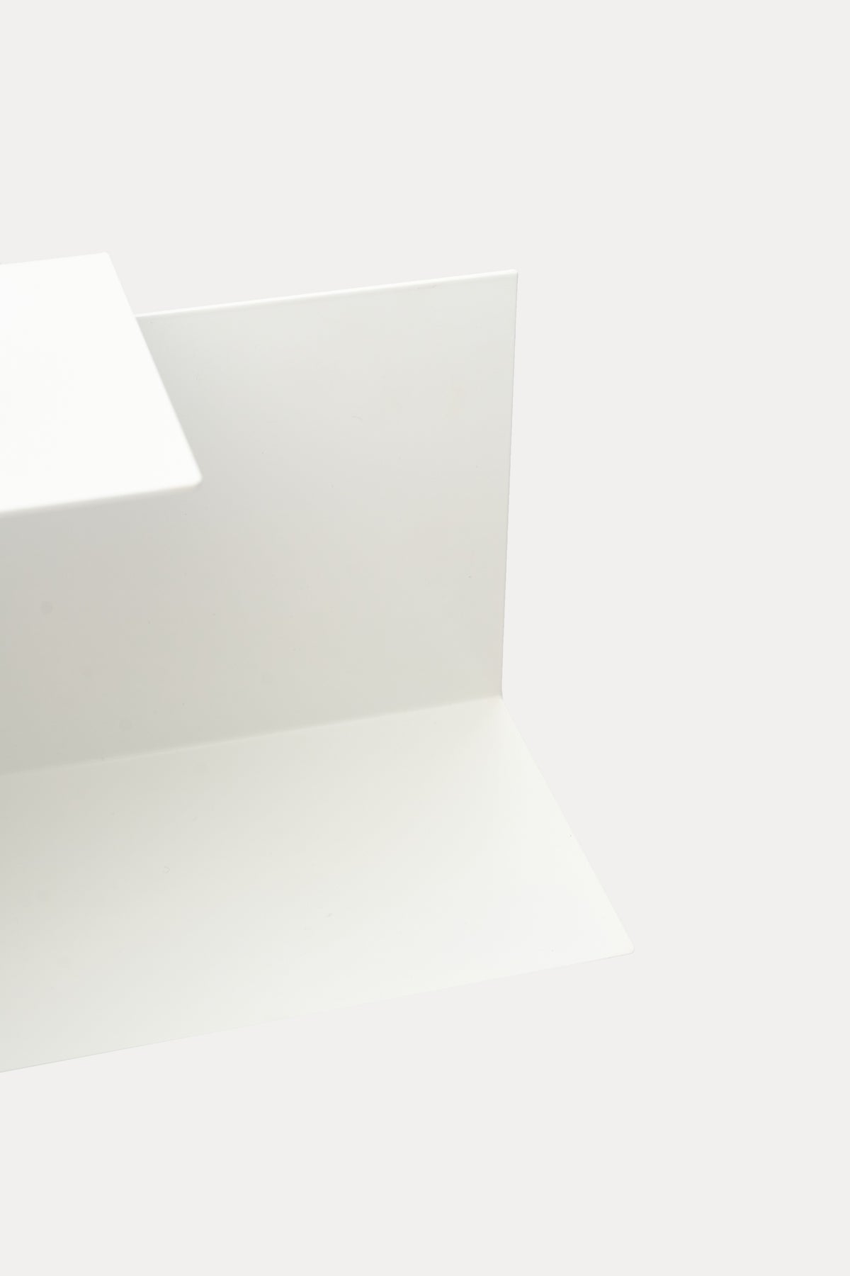 LYNX floating shelf in Chalk powder coated steel, angled close-up of fold and ledge, bright white