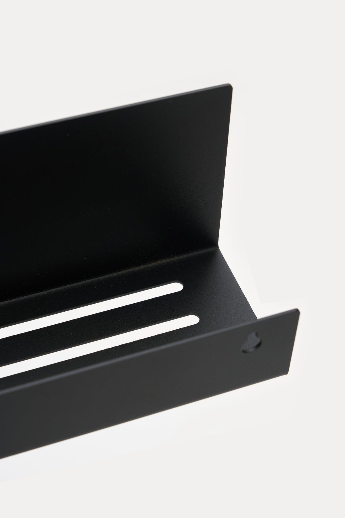 METI bathroom shelf in Graphite powder coated steel, angled close-up of the slotted drainage tray, jet black