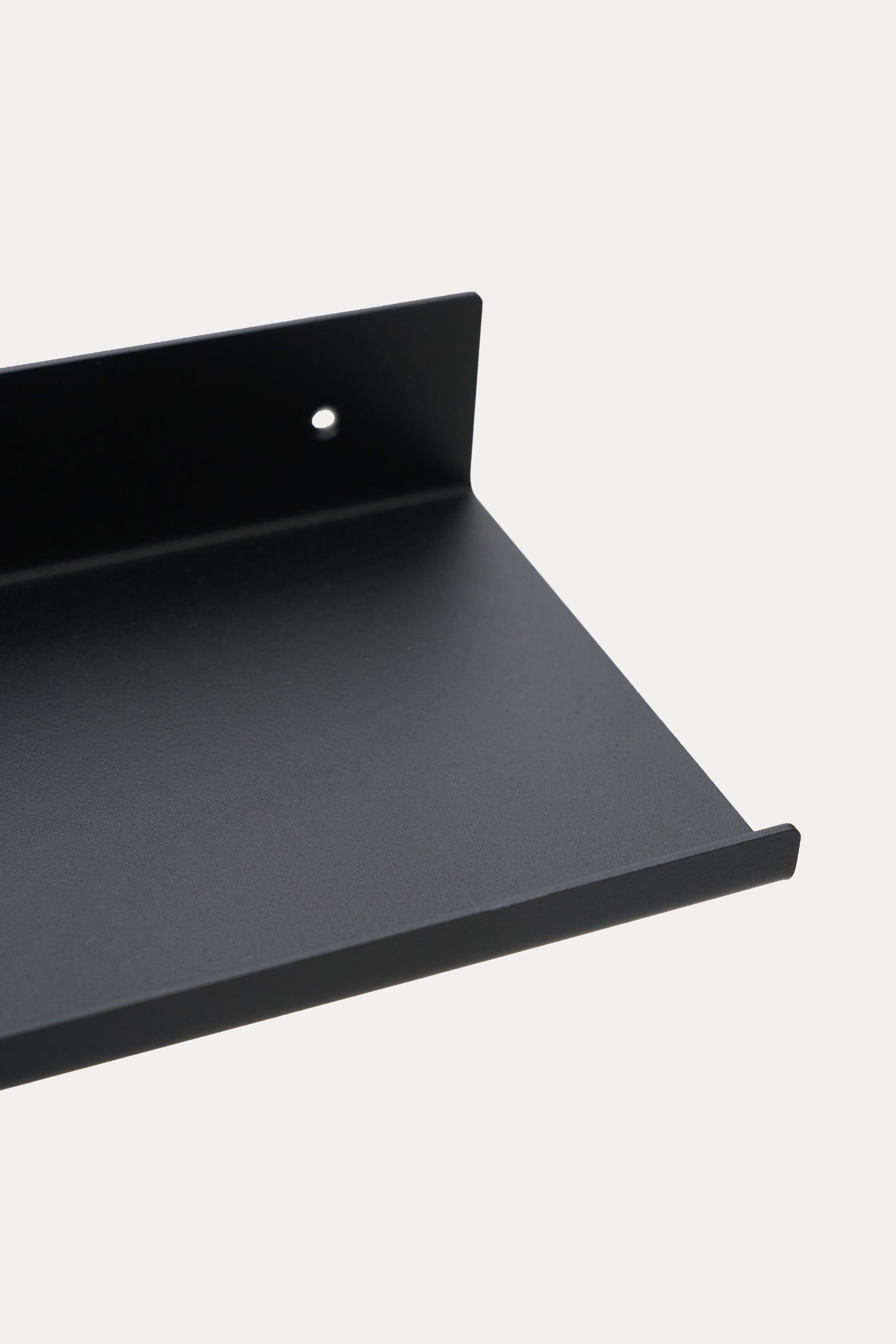 LUME bedroom shelf in Graphite powder coated steel, close-up of the ledge and front lip, jet black, fine grain visible