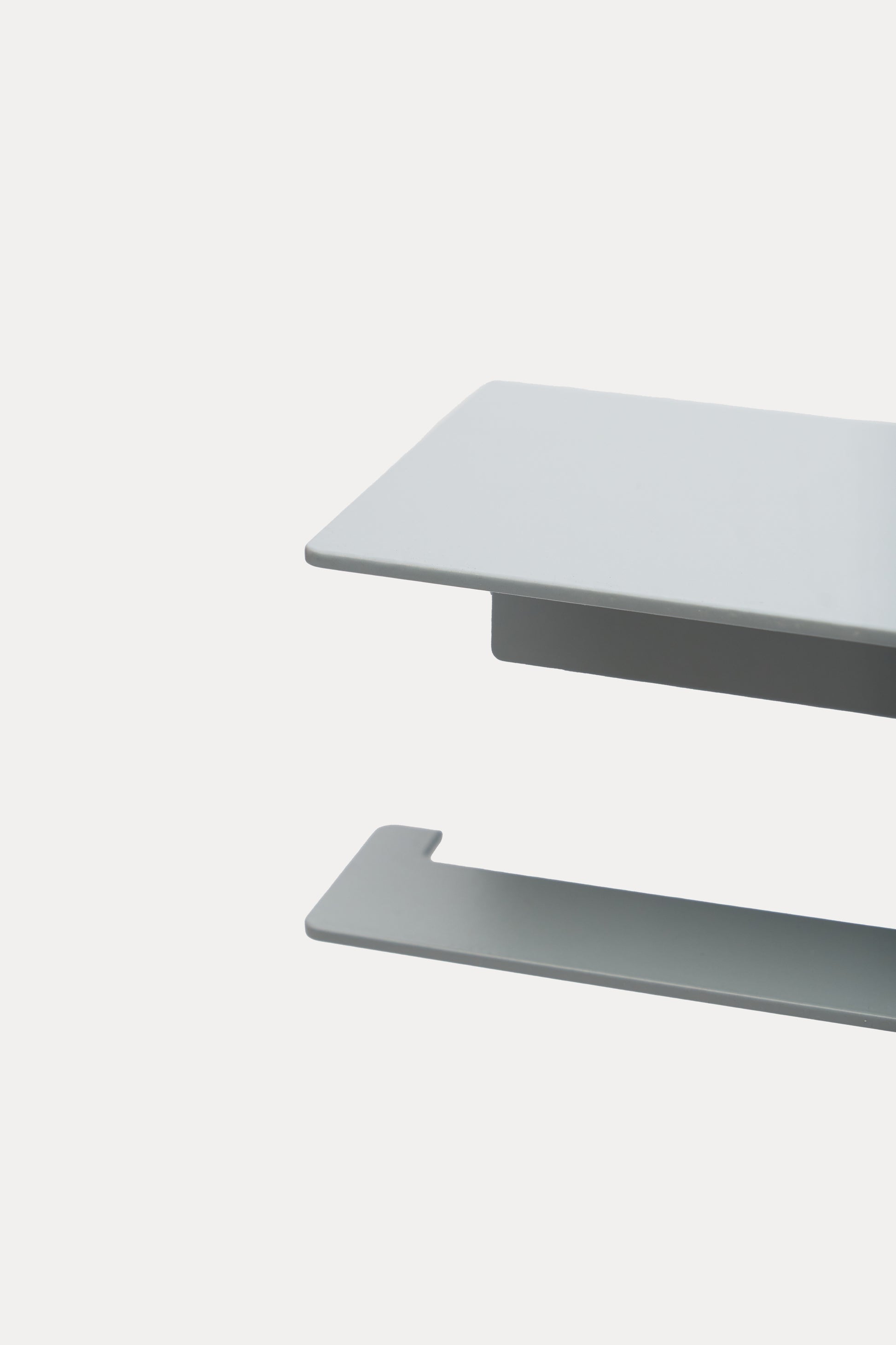 NYVE toilet paper holder in powder coated steel, close-up of the top shelf and hook arm in a pale grey powder coat