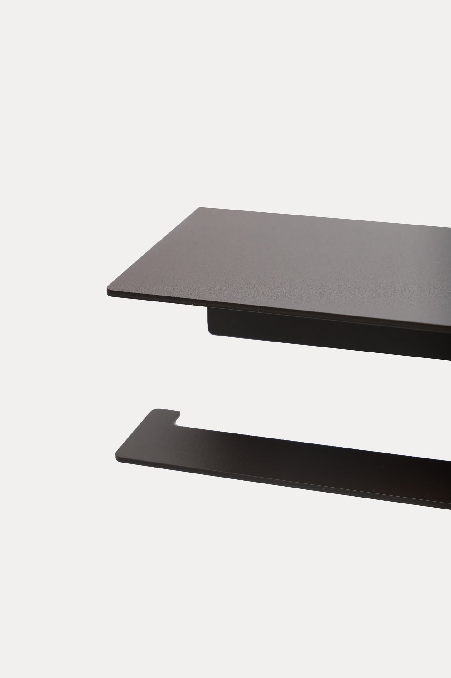 NYVE toilet paper holder in Umber powder coated steel, RAL 8022, black brown, close view of the surface