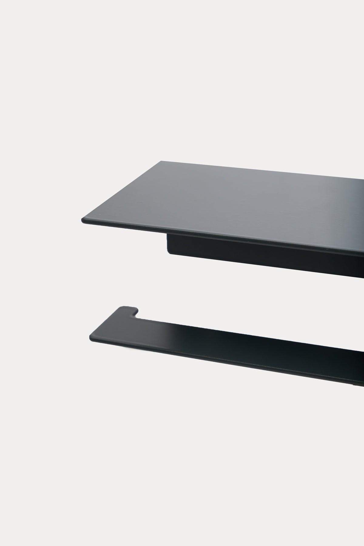 NYVE toilet paper holder in powder coated steel, close-up over the top shelf and arm, dark matte anthracite