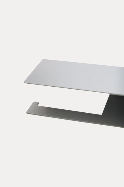 NYVE toilet paper holder in powder coated steel, close-up of the top shelf and hook arm in a pale grey powder coat, second angle