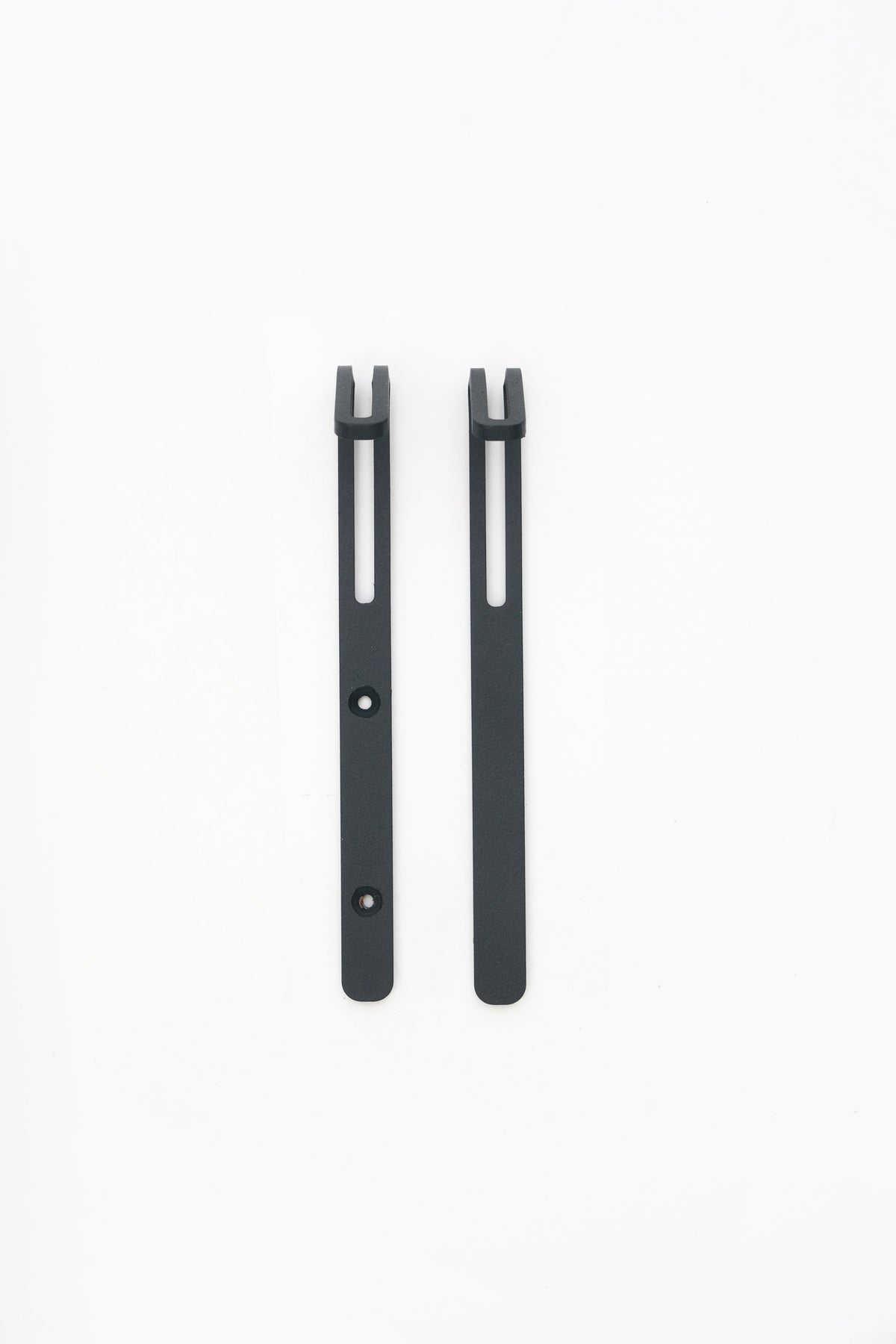 AIKI wall hook in powder coated steel, screw and tape versions side by side, dark anthracite grey with visible grain