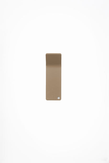CORE wall hook in Linen powder coated steel, RAL 1019, warm beige, photographed straight on