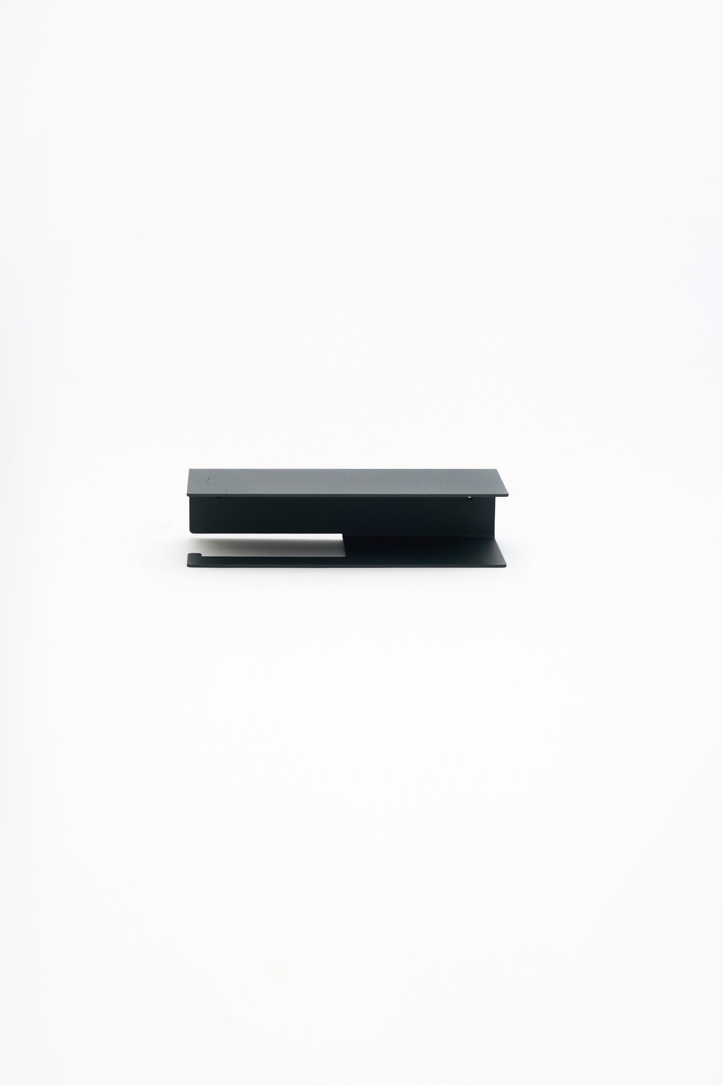 NYVE toilet paper holder in powder coated steel, full front view of the compact holder, matte black
