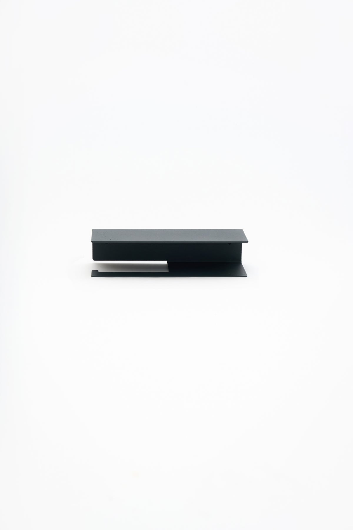 NYVE toilet paper holder in powder coated steel, full front view of the compact holder, matte black