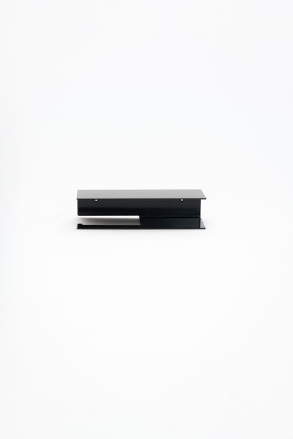 NYVE toilet paper holder in powder coated steel, full front view of the compact holder, glossy black, two screw holes