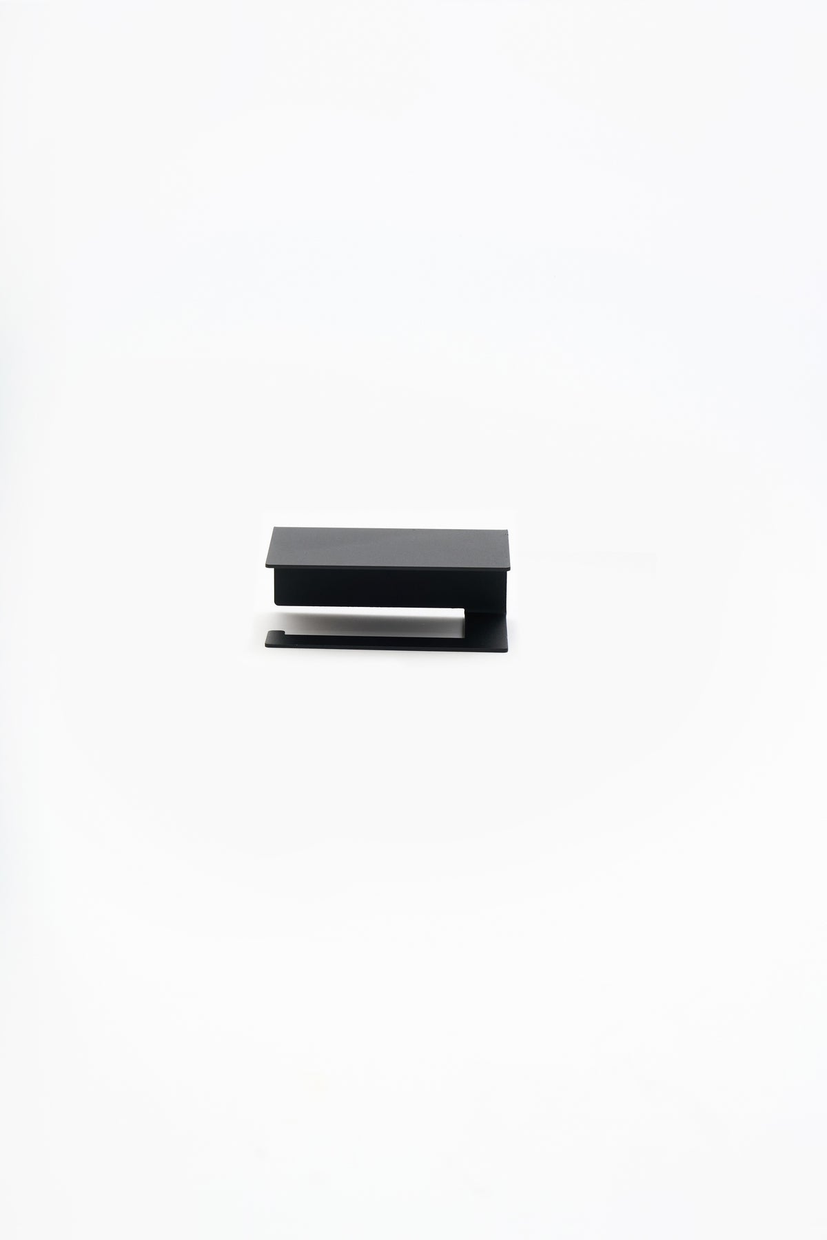 NYVE toilet paper holder in powder coated steel, straight studio front view of the holder, matte black