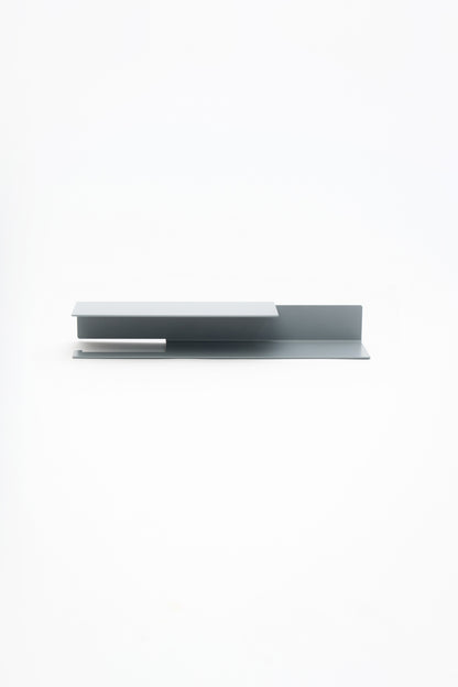 NYVE toilet paper holder in powder coated steel, full front view of the medium holder in a pale grey powder coat